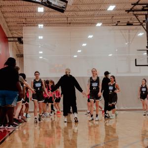 Players and coach congratulating each other.
